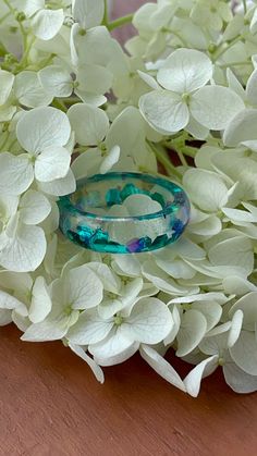 A beautiful iridescent chunky glitter resin ring. Both blue, turquoise, green, and purple chunky glitter is mixed with clear eco epoxy resin to create this pretty and elegant ring. This is a shiny ring. This epoxy resin ring is perfect for stacking! It is Cambridge style ring and is smooth and comfortable to wear. These rings can be used as an affordable alternative engagment rings or can be given as a gift for a special occasion. All my resin rings are handmade with silicone molds. They are also hand-sanded and polished, to be smooth and comfortable to wear. Given the nature of the resin, my rings may contain tiny bubbles and imperfections, but I always try to make them as perfect as possible. The listing is for ONE stacking ring with mixed chunky glitter. MEASUREMENT Shiny Ring, Best Friend Rings, Ring Resin, Resin Rings, Shiny Rings, Friend Rings, Resin Ring, Alternative Engagement Rings, Turquoise Green