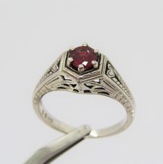 Vintage Sterling Silver Ruby Carved Filigree Ring....Marked 925...Total of weights 3.0grams... Size 7...Measure of Face 8.9MM...It's in very good condition. Classic Formal Ruby Ring Stamped 925, Classic Engraved Ruby Ring, Classic Ruby Ring In Sterling Silver, Classic Silver Engraved Birthstone Ring, Classic Engraved Silver Birthstone Ring, Classic Sterling Silver Ruby Ring Stamped 925, Classic Silver Ruby Ring With Diamond Cut, Classic Engraved Round Ruby Ring, Classic Engraved Ruby Ring For Anniversary