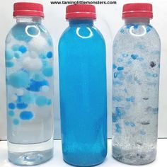 three water bottles filled with blue and white liquid