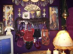 there are many purses hanging on the wall in this living room with purple walls