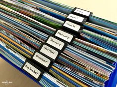 a stack of folders with labels on them