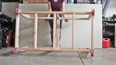 a woman standing in front of a wooden frame