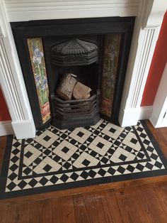 a black and white tile fireplace with red walls