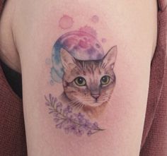 a woman with a cat tattoo on her thigh