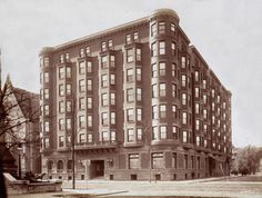 an old black and white photo of a large building with lots of windows on it