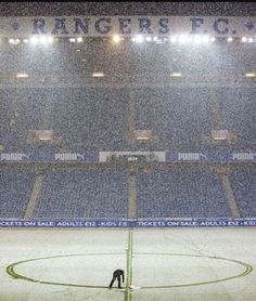 an empty soccer field with the lights on during a snow storm at rangers stadium in toronto, canada