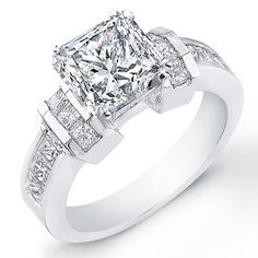 a princess cut diamond engagement ring with three baguetts on the shoulders and shoulder