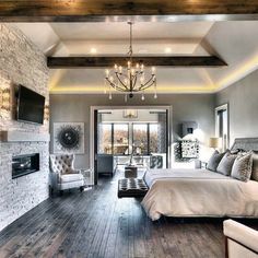 a bedroom with a bed, fireplace and tv in it's centerpieces