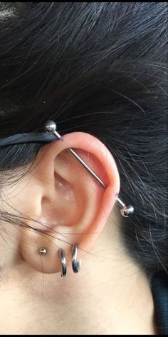 an ear piercing is being worn on the back of a woman's head