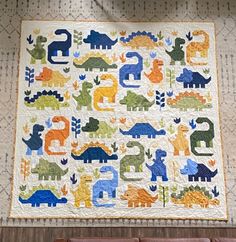 a child's quilt with dinosaurs on it