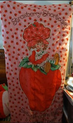 a strawberry shortcake towel hanging on the wall