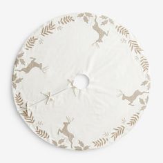 a white and gold deer print round play mat with an arrow in the middle, on a white background