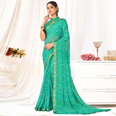 Sea Green colored saree is made from chiffon fabric which is highlighted with beautiful bandhani printed work as shown. Comes along with unstitched chiffon blouse piece which you can customise as per your design/style. Occasion - You can wear this saree for casual and daily wear. Note:- the actual product may differ slightly in color and design from the one illustrated in the images when compared with computer or mobile screen. Measurements: Saree : Chiffon : 5.5 Mtrs Blouse : Chiffon : 0.8 Mtr Material: Chiffon Stitch Type: Unstitched Country of Origin: India Care Guide: Dry Clean Bandhani Print Georgette Blouse Piece For Navratri, Unstitched Georgette Blouse With Bandhani Print, Georgette Blouse Piece With Bandhani Print In Traditional Drape, Georgette Blouse With Traditional Bandhani Print Drape, Georgette Saree With Bandhani Print In Traditional Drape, Traditional Georgette Blouse Piece With Bandhani Print, Georgette Saree With Bandhani Print, Festive Green Chiffon Saree, Green Georgette Saree With Bandhani Print