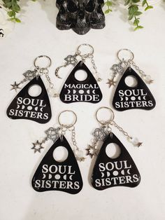 six keychains with the words soul sisters on them and a skull in the background