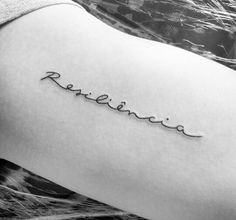 a woman's thigh with the word believe tattooed on her lower arm and bottom