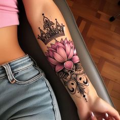 a woman's arm with a flower and crown tattoo on the left side of her arm