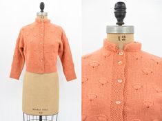 "Vintage 1950s wool knit. Vibrant creamsicle orange. Fan design throughout. Long sleeves and high 1 1/2\" collar. Front button closure. Unlined.  State of garment | excellent  Measurements ✂--- Best fit |  Large *has give Bust | up to 38-40 \" Shoulders | not specified / apron 15\" Shoulder to waist | not specified  Sleeves | aprox 19 \" Waist | 30.5- 32\" Total length (shoulder to hem) | 19 1/4\" Tag | none present  ★★Visit The Shop★★ http://www.etsy.com/shop/seaofvintage ➸ Find the shop on Ins Vintage Orange Sweater For Fall, Retro Orange Cardigan For Winter, Retro Orange Winter Cardigan, Vintage Wool Sweater For Spring, Fitted Vintage Wool Sweater, Retro Fitted Wool Sweater, Fitted Wool Sweater In Vintage Style, Retro Fitted Sweater With Button Closure, Vintage Fitted Sweater With Buttons