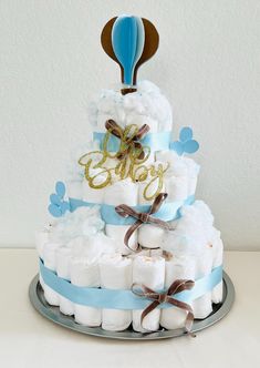 a diaper cake with blue and white decorations