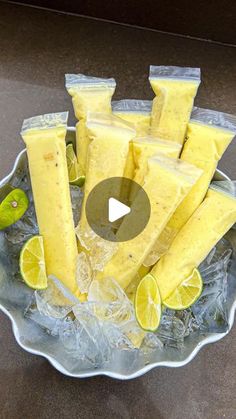 a bowl filled with lemon wedges on top of ice