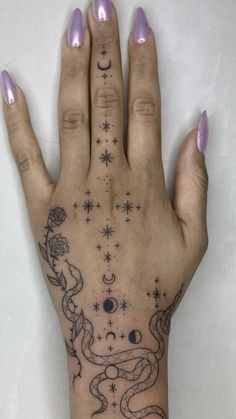 a woman's hand with tattoos on it