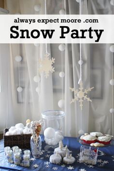 a table with snow decorations and cupcakes on it