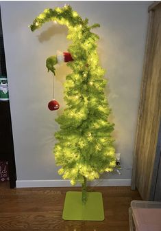 a green christmas tree with lights on it