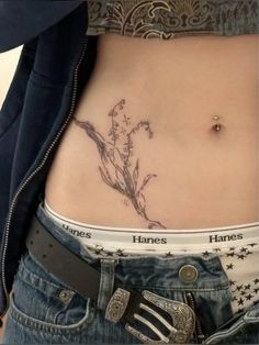 a woman's stomach with tattoos on it