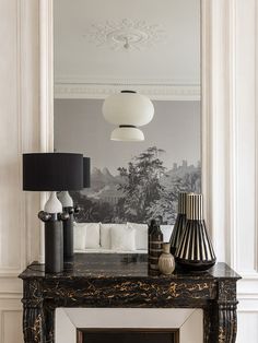 a black and white living room with an ornate fireplace