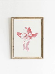 a pink and white painting hanging on the wall