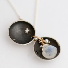 This modern locket is composed of two sterling silver domes cut with a moon and star design, hiding a luminous natural moonstone drop inside. A gift so say, "You are my moon & my stars..." sterling silver pendant and chain 14k gold fill accent ring 5/8" diameter moonstone 18" chain Modern Locket, Moon And Star Design, You Are My Moon, Moon And Star, Star Design, Silver Moon, Moon Stars, Star Designs, Say You