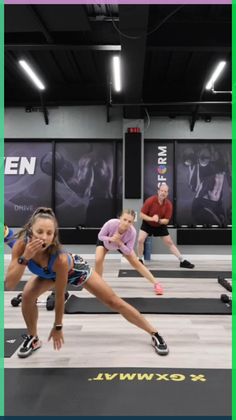 people are doing exercises in an indoor gym