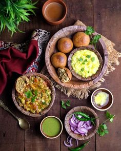 an assortment of food is displayed on a wooden table