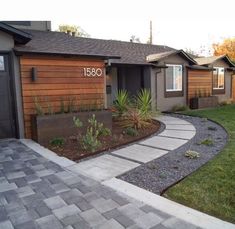 a house with landscaping in front of it and the number 081 on the door