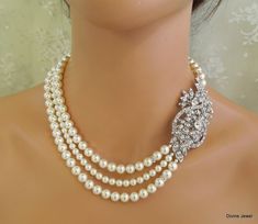 "This glamorous necklace has a vintage inspired brooch and Swarovski pearls in white. Brooch has clear rhinestones and leaves, and measures 3\" by 1 1/2\" at its widest point. Pearls measure 8, 6 mm in the middle strand accented with rhinestone roundelles. Necklace is 17\" long inner strand. Finished off with a silver hook and eye closure. Pearls can be substituted with ivory/cream color and size adjusted. Convo me with color preference and if you need me to adjust the length and will be happy t Wedding Necklace Pearl, Pearl Necklace Bridal, Bridal Pearl Necklace, Pearl Necklace Wedding, Necklace Bridal, Pakistani Bridal Dresses, Necklace Wedding, Necklace Pearl, Rhinestone Wedding