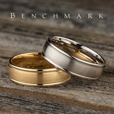 two gold and silver wedding bands on top of each other with the words benchmark written above them