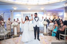 a bride and groom walking down the aisle after their wedding ceremony in front of an audience