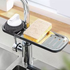 a kitchen sink with a sponge and brush on it