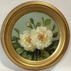 a painting of three white roses in a gold frame