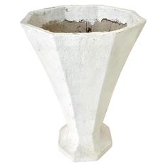 a large white vase sitting on top of a table