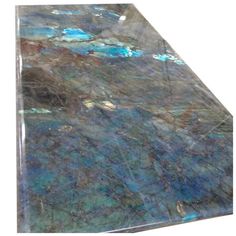 a marble counter top with blue, green and purple colors on the surface is shown