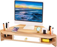 a computer monitor sitting on top of a wooden desk