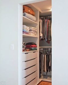 an open closet with clothes and other items