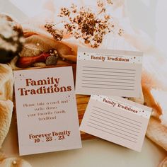 two family traditions cards sitting next to each other on top of a pile of bread