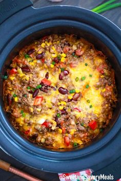 a crock pot filled with chili cheese and beans