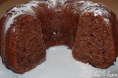 a chocolate bundt cake with powdered sugar on top