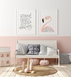 two flamingos are hanging on the wall above a white bench with pillows and toys