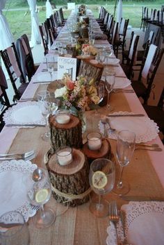 a long table is set up with place settings and centerpieces for the tables