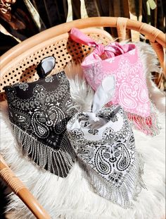 three bags sitting on top of a white fur covered floor next to a wicker chair