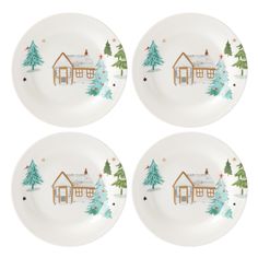 four white plates with houses and trees painted on them