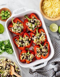 an image of stuffed bell peppers with rice and vegetables in the dish on the table